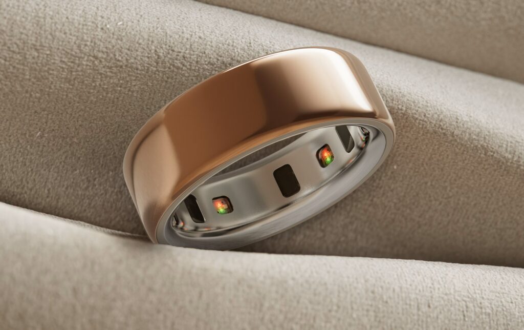 Close-up of the Oura Ring 4 in brushed titanium, showcasing its recessed health sensors for sleep and recovery tracking.
