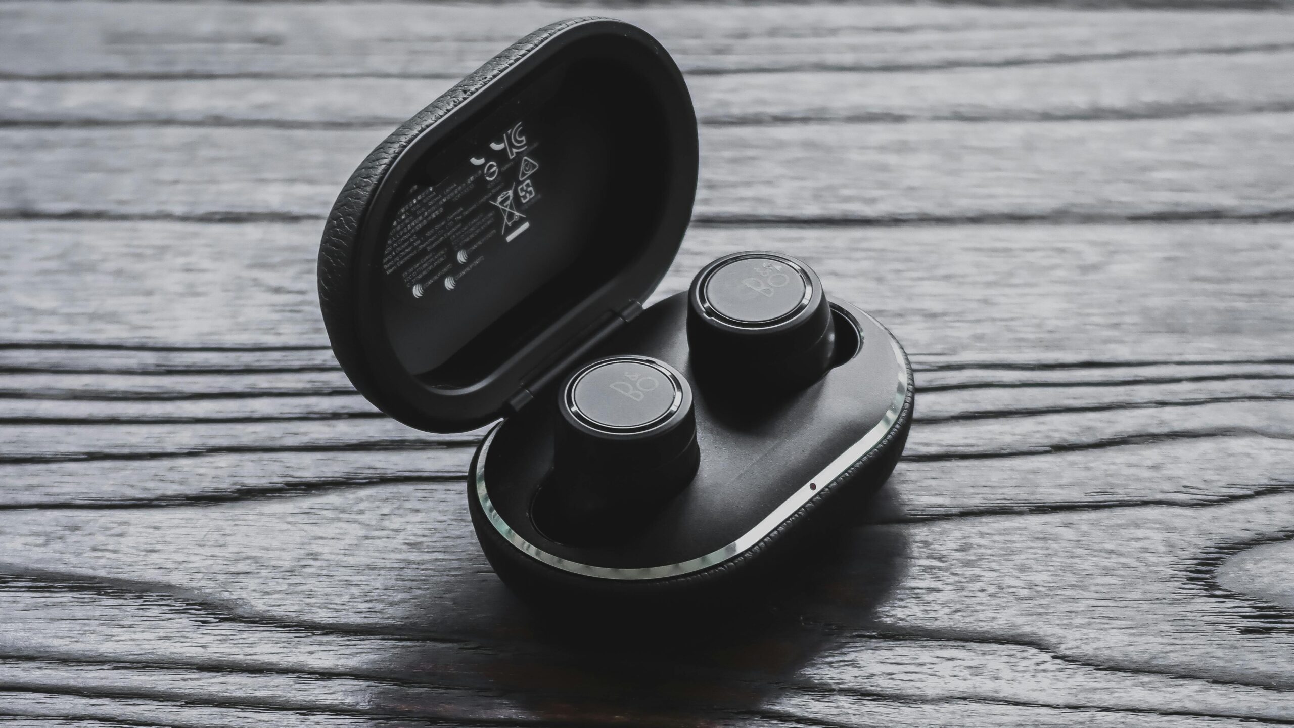 Pair of wireless earbuds in an open charging case.